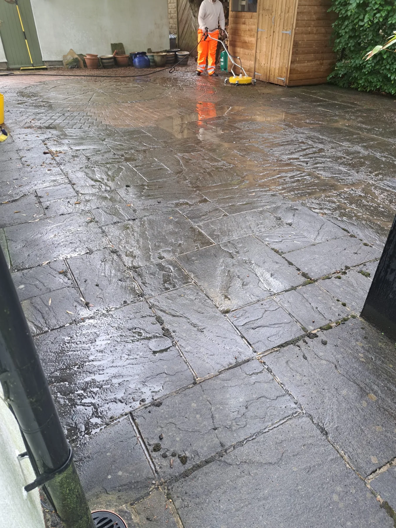 Pressure washing equipment being used on paving in North Leeds